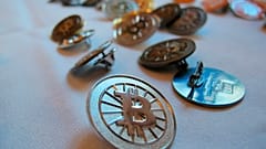 Bitcoin buttons are displayed on a table at the Inside Bitcoins conference in Berlin.
