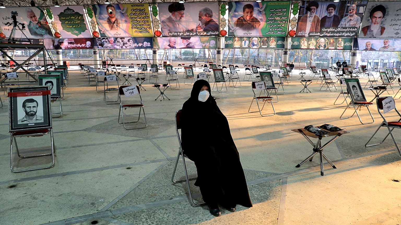 An Iranian woman wearing a mask attends a ceremony on the occasion of first anniversary of death of Iranian Revolutionary Guards general Qasem Soleimani, Tehran, Jan 1, 2021.
