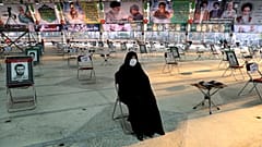 An Iranian woman wearing a mask attends a ceremony on the occasion of first anniversary of death of Iranian Revolutionary Guards general Qasem Soleimani, Tehran, Jan 1, 2021.