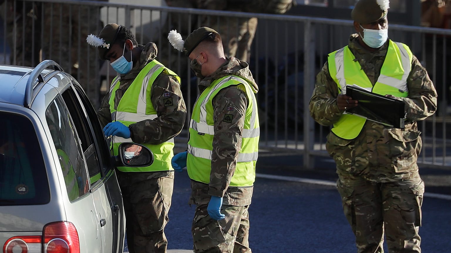 Soldiers carry out a COVID test on a driver at the entrance to The Port of Dover in Kent, England, Friday, Dec. 25, 2020.