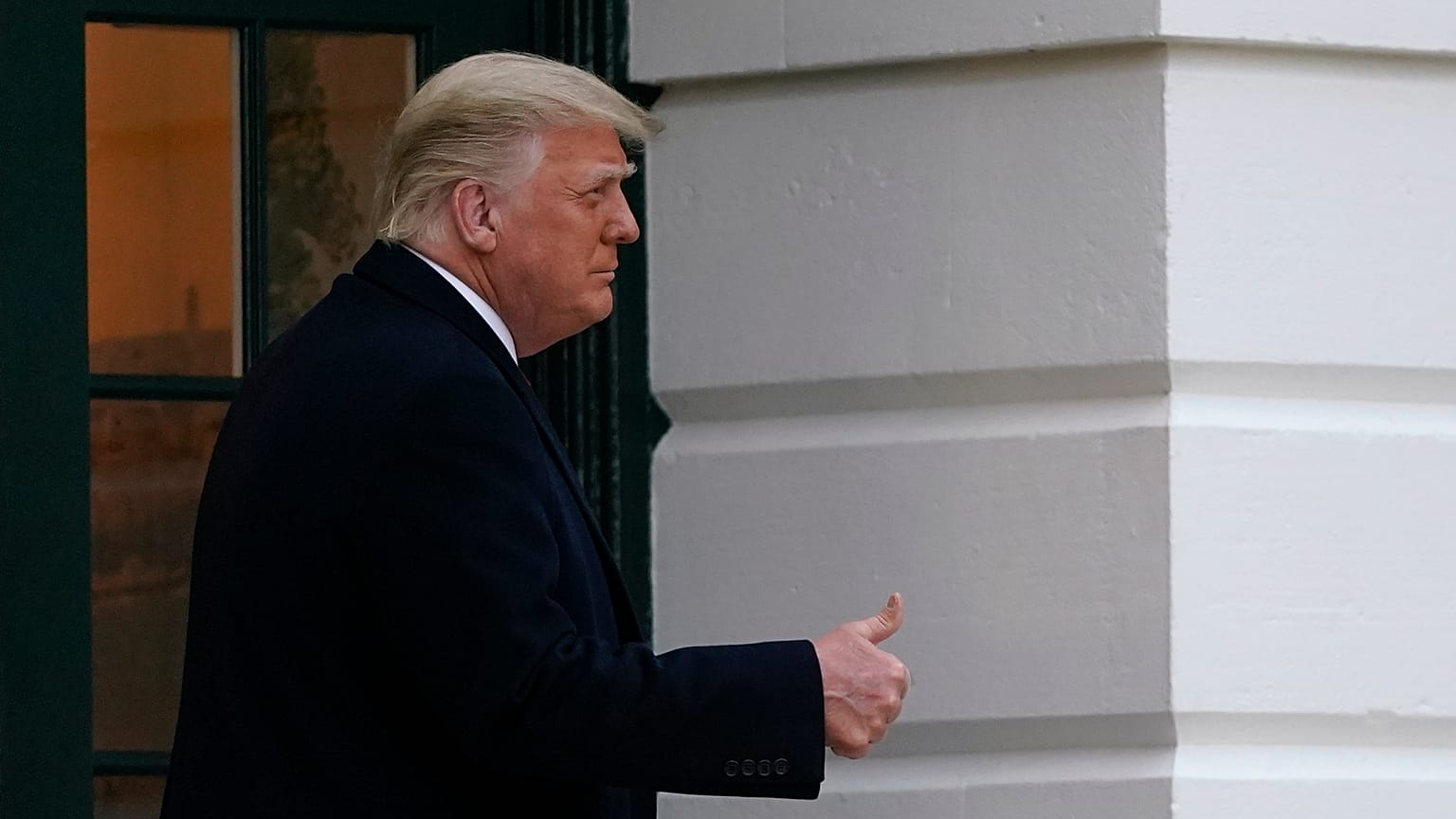 President Donald Trump gestures to supporters as he walks onto the South Lawn of the White House in Washington, Saturday, Dec. 5, 2020.
