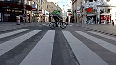 A cyclist drives on a shopping street in downtown Vienna, Austria