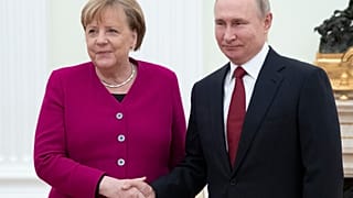 Russian President Vladimir Putin, right, and German Chancellor Angela Merkel pose for a photo prior to the talks in the Kremlin in Moscow, Russia, Jan. 11, 2020.
