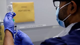 Senior Clinical Research Nurse Ajithkumar Sukumaran prepares the COVID 19 vaccine to administer to a volunteer, at a clinic in London, Wednesday, Aug. 5, 2020.