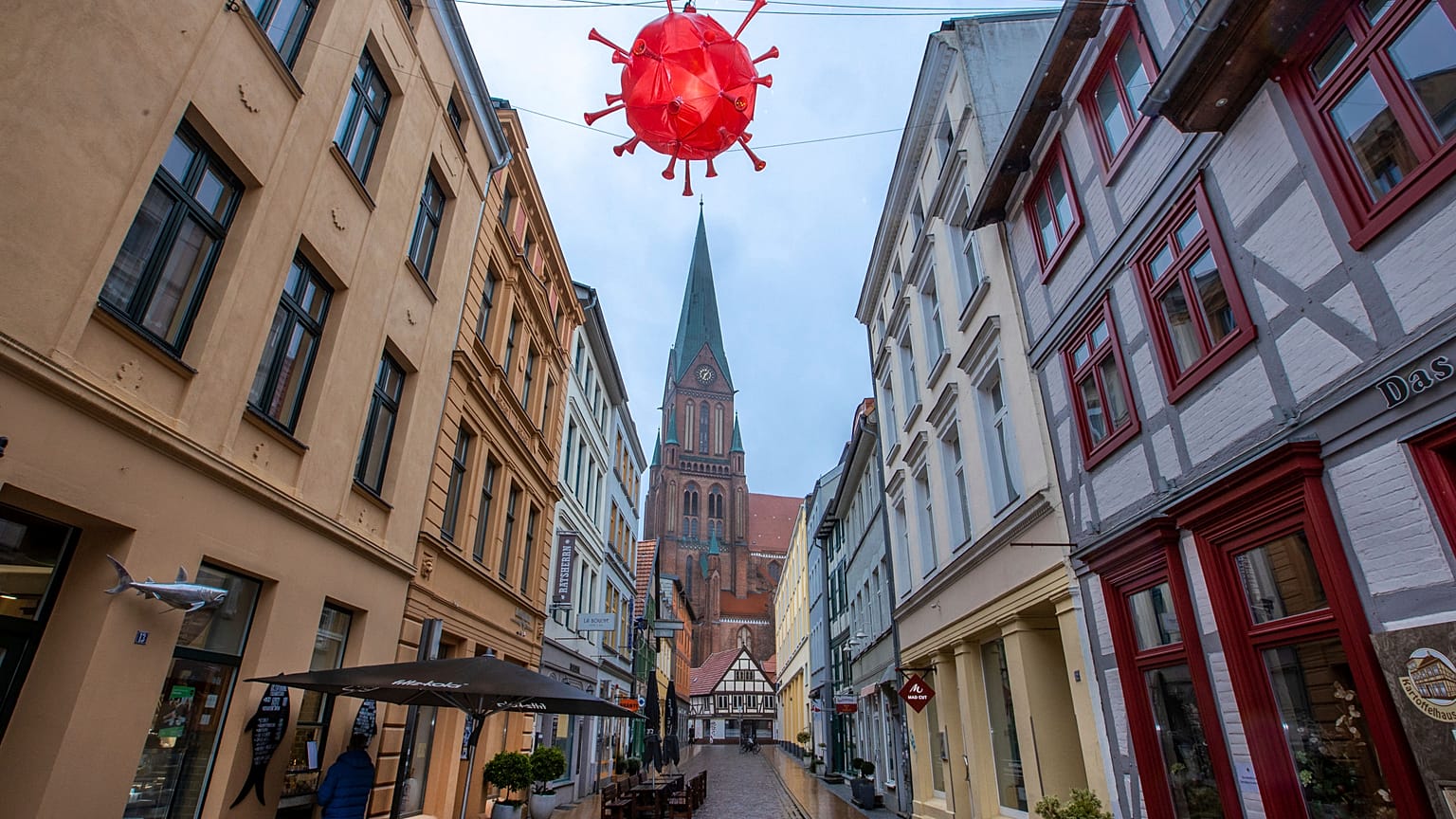 A COVID-inspired decoration hangs above a street in Schwerin, Germany, Tuesday, Jan. 5, 2021.