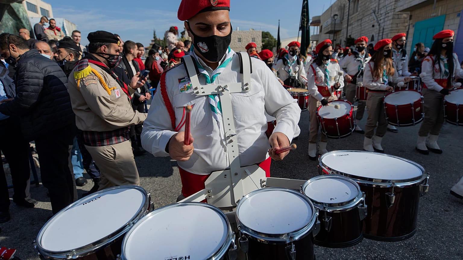 Palestinian scout bands parade outside the Church of the Nativity