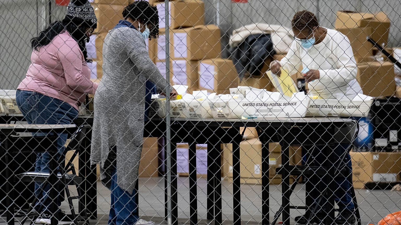 FILE PHOTO Fulton County Georgia elections workers process absentee ballots for the Senate runoff election in Atlanta on Tuesday, Jan. 5, 2021. 