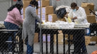 FILE PHOTO Fulton County Georgia elections workers process absentee ballots for the Senate runoff election in Atlanta on Tuesday, Jan. 5, 2021.