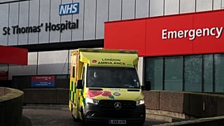An ambulance drives of a hospital in London, Wednesday, Dec. 30, 2020.