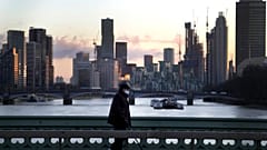 A man walks over Westminster Bridge as the sun sets in London, Wednesday, Jan. 6, 2021.