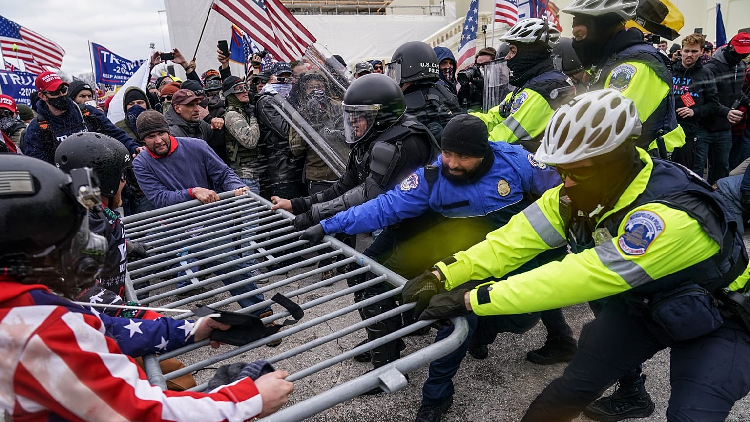 Trump supporters try to break through a police barrier, Wednesday, Jan. 6, 2021, at the Capitol in Washington.