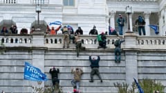 Supporters of President Donald Trump climb the west wall of the the U.S. Capitol on Wednesday, Jan. 6, 2021, in Washington. 