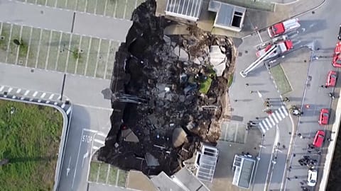 Firefighers on scene of giant sinkhole in Naples