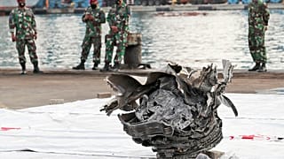 Investigators of Indonesian National Transportation Safety Committee inspect parts of Sriwijaya Air SJ-182 recovered from the Java Sea where it crashed on Saturday 9 Jan. 2021