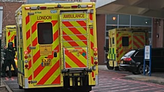 Ambulances are parked at the emergency arrival at Charing Cross hospital in London, Friday, Jan. 8, 2021.