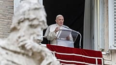 Pope Francis delivers his message during the Angelus noon prayer from the window of his studio overlooking St.Peter's Square at the Vatican.