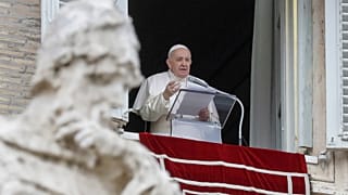 Pope Francis delivers his message during the Angelus noon prayer from the window of his studio overlooking St.Peter's Square at the Vatican.