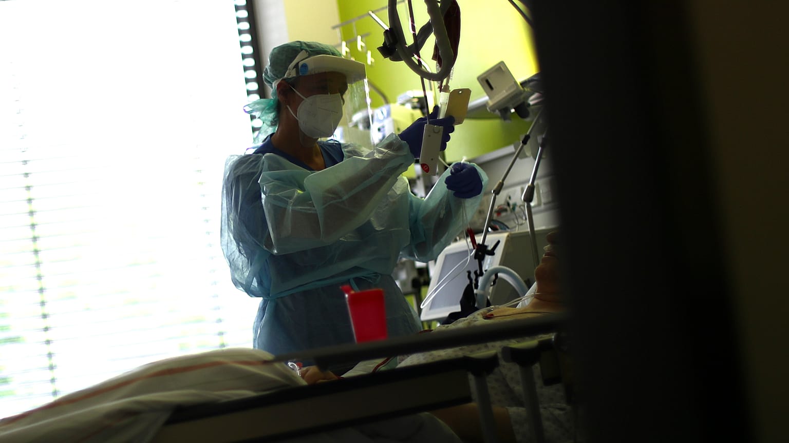 File: In this Wednesday, April 29, 2020 photo a nurse assists a COVID-19 patient at one of the intensive care units of the hospital in Muehldorf am Inn, Germany. 