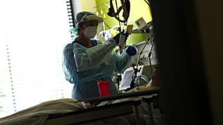 File: In this Wednesday, April 29, 2020 photo a nurse assists a COVID-19 patient at one of the intensive care units of the hospital in Muehldorf am Inn, Germany. 