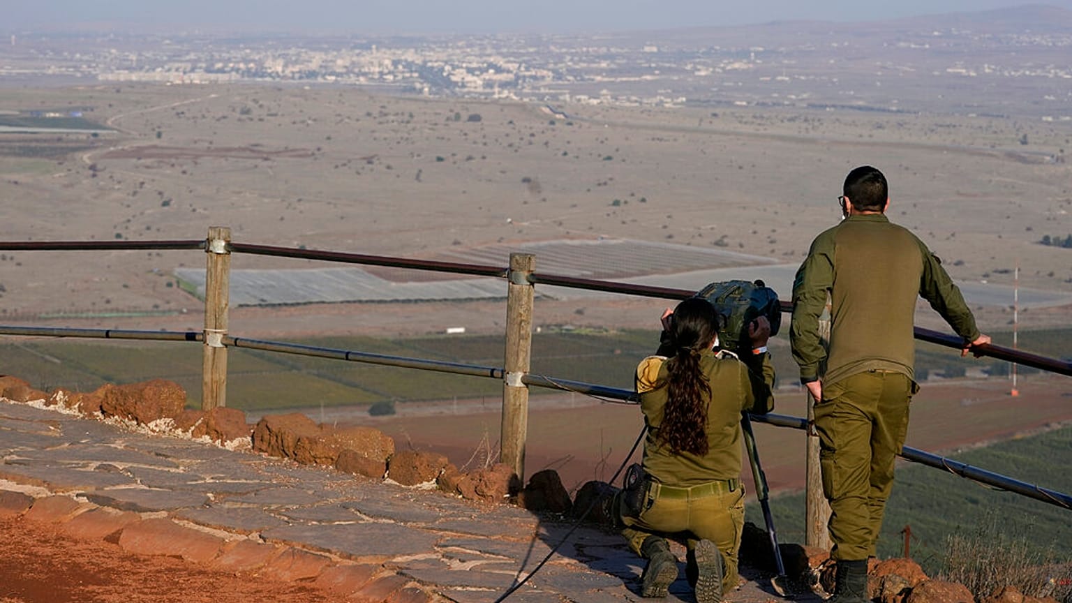 Israeli soldiers observe Al Qunaitra, Syria, across the border from Mount Bental in the Israeli-controlled Golan Heights, Thursday, Nov. 19, 2020.