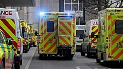 Ambulances queue outside the Royal London Hospital in London
