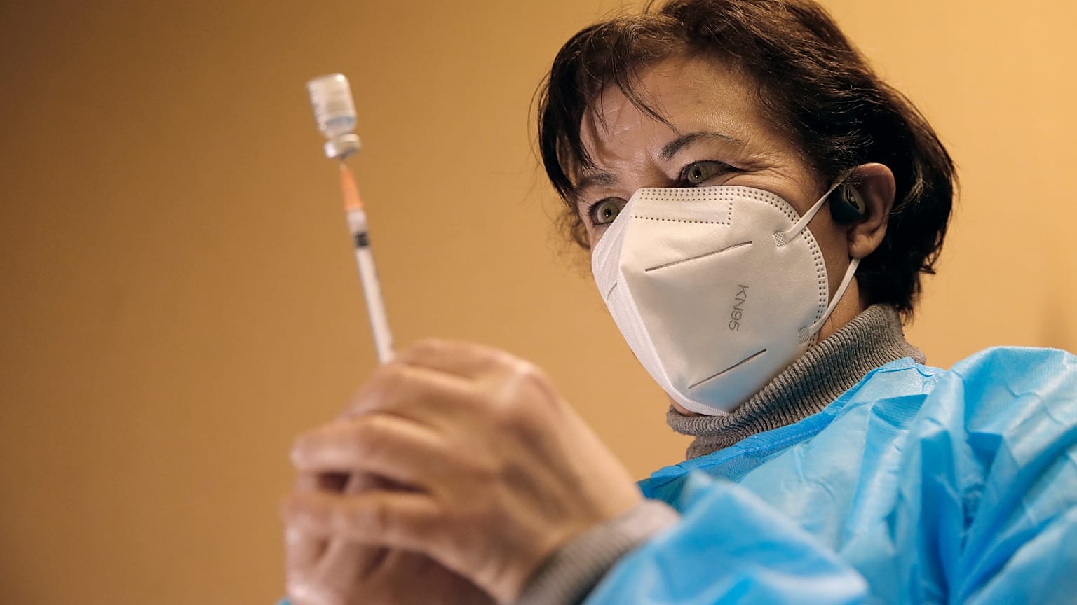 A nurse, Ines, prepares a Pfizer-BioNTech COVID-19 vaccine to be administered to a health care worker at a coronavirus vaccine center in Poissy, France, Friday, Jan.8, 2021.
