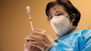 A nurse, Ines, prepares a Pfizer-BioNTech COVID-19 vaccine to be administered to a health care worker at a coronavirus vaccine center in Poissy, France, Friday, Jan.8, 2021.
