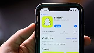 The App Store page for Snapchat is displayed on a mobile phone.