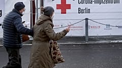 Two persons arrive at a new coronavirus, COVID-19, vaccination center in the 'Erika-Hess-Ice-Stadium' in Berlin