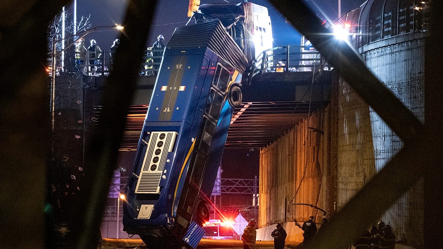 A bus in New York City which careened off a road in the Bronx neighborhood of New York is left dangling from an overpass Friday, Jan. 15, 2021.