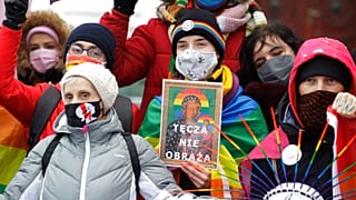 Human rights activists show an altered image with colors symbolizing LGBT rights as they gathered outside the provincial court in Plock, Poland, Jan. 13, 2021  