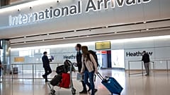 A sign at Heathrow Airport Terminal 5 arrivals warns of Coronavirus, in London, Tuesday, March 24, 2020