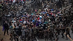 Soldaten drängten die Menschen aus Honduras an einer Autobahn-Sperre zurück