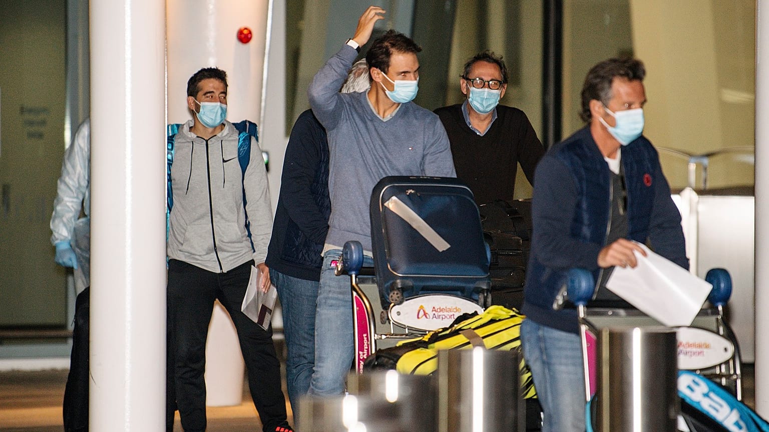 Spain's Rafael Nadal, center, arrives at Adelaide Airport ahead of the Australian Open tennis championship, Adelaide, Australia, Thursday, Jan. 14, 2021.
