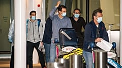 Spain's Rafael Nadal, center, arrives at Adelaide Airport ahead of the Australian Open tennis championship, Adelaide, Australia, Thursday, Jan. 14, 2021.