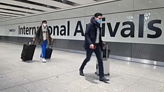 Passengers arrive at Heathrow airport the day before the UK government closes all travel corridors