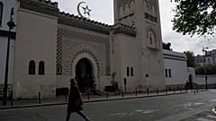 A woman walks outside the Paris mosque, Thursday, Oct. 29, 2020.