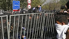 Hungarian police use pepper spray on migrants at the "Horgos 2" border crossing into the Hungary, near Horgos, Serbia, Wednesday, Sept. 16, 2015.