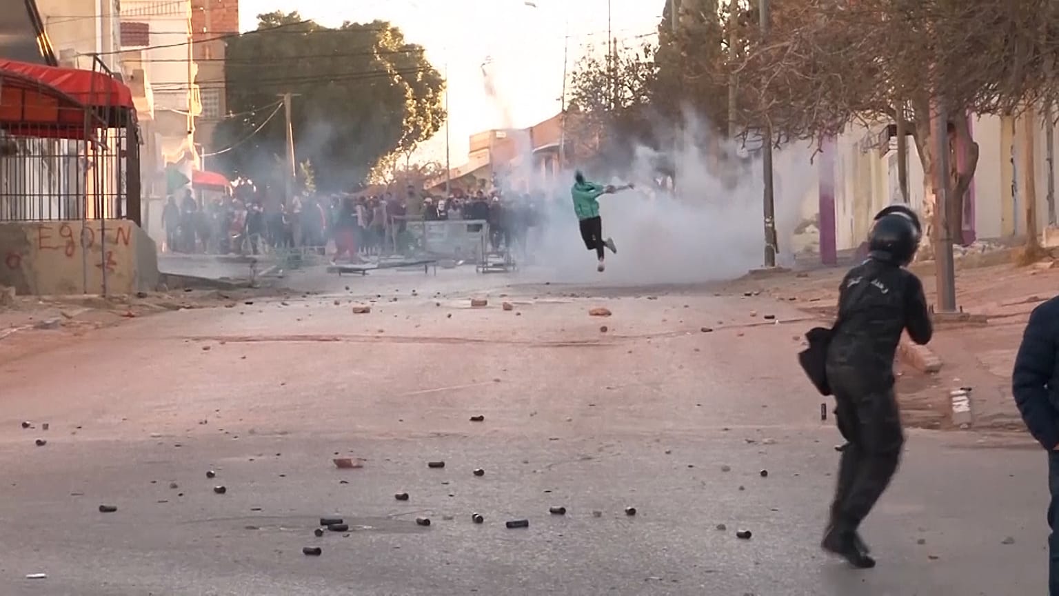 Police firing tear gas canisters, protesters throwing objects