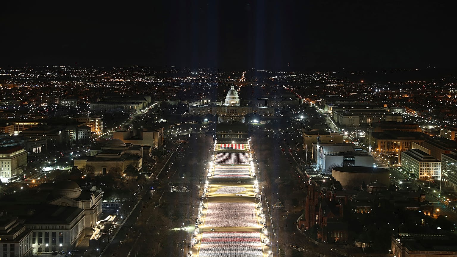 The U.S. Capitol building is seen as the "Field of Flags" are illuminated on the ground on the National Mall ahead of the inauguration ceremonies, Washington DC, Jan. 18, 2021