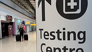 Travellers walk towards the Covid-19 testing centre at Heathrow Airport in London, Sunday, Jan. 17, 2021. 