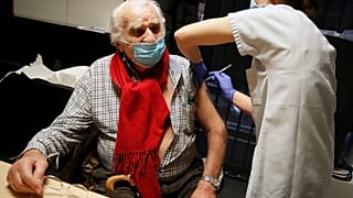 Mr Albert from Paris, 94 years old, receives the Pfizer-BioNTech vaccine against COVID-19 at a vaccination centre in Paris, Jan. 18, 2021.
