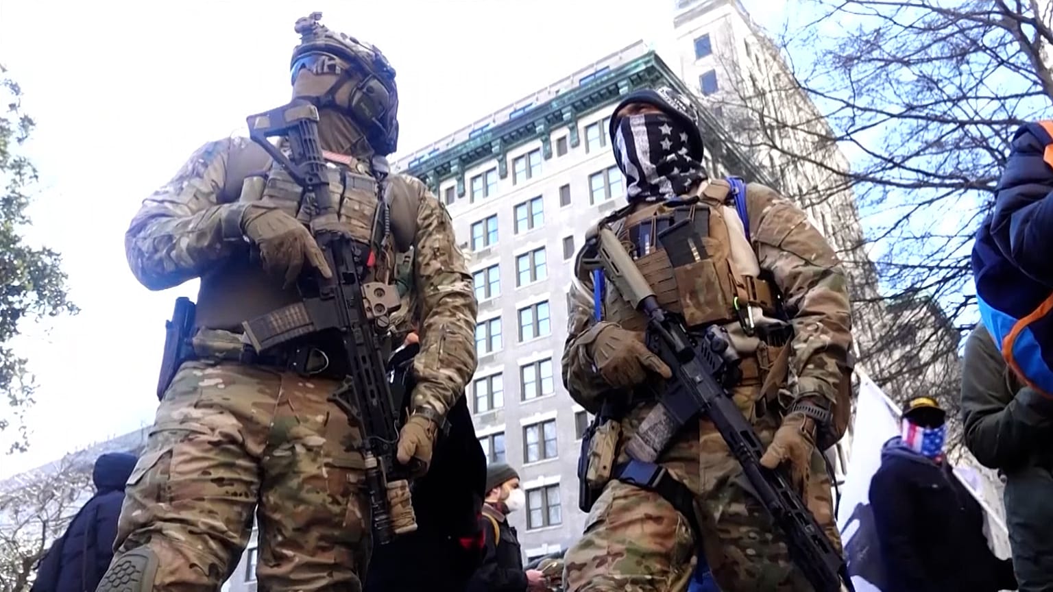 Members of anti-government 'Boogaloo' militia group in military gear.