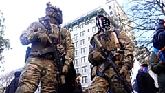 Members of anti-government 'Boogaloo' militia group in military gear.