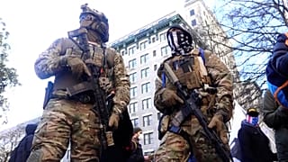 Members of anti-government 'Boogaloo' militia group in military gear.