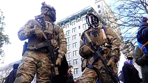 Members of anti-government 'Boogaloo' militia group in military gear.