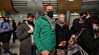 Alexei Navalny and his wife Yuliastand in line at the passport control after arriving at Sheremetyevo airport, outside Moscow, Russia, Sunday, Jan. 17, 2021.