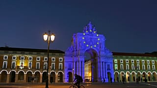 The arch at Lisbon's Comercio square is illuminated to mark the start of the Portuguese Presidency of the Council of the European Union, Friday, Jan. 1, 2021.