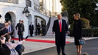 President Donald Trump and first lady Melania Trump stop to talk with the media as they walk to board Marine One on the South Lawn of the White House, Jan. 20, 2021.