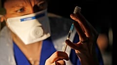 Doctor Claire Chatt prepares the Pfizer-BioNTech vaccine inside Salisbury Cathedral in Salisbury, England
